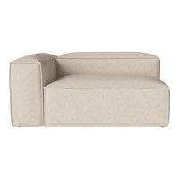 Beige upholstered chaise lounge with a smooth, textured fabric and minimalist design. Ideal for modern decor.