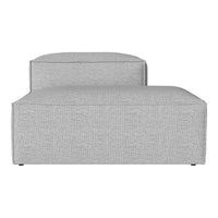 Gray upholstered chaise lounge with a textured pattern, featuring clean lines and modern design.