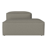Sleek, modern chaise lounge in soft taupe fabric with subtle textured pattern, perfect for contemporary decor.
