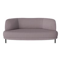 "Round lavender accent sofa with a sleek, minimalist design and smooth fabric upholstery."