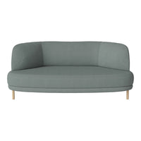 Light teal curved sofa with a smooth fabric surface and natural wooden legs, minimalist design.