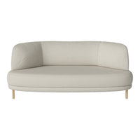 Soft beige curved sofa with light wooden legs, featuring a minimalist design and smooth upholstery.