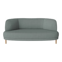 Curved, modern sofa in soft sage green fabric with natural wood legs, perfect for contemporary living spaces.