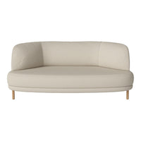 Beige curved sofa with a minimalist design and natural wooden legs, offering a modern and cozy aesthetic.