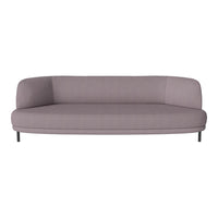 Modern curved sofa in soft lavender fabric with a smooth, minimalist design and sleek black legs.