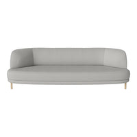 Light grey curved sofa with a smooth fabric texture and natural wood legs, perfect for modern interiors.