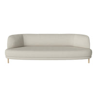Cream-colored curved sofa with a smooth texture and understated design, featuring light wooden legs.