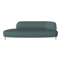 Teal curved sofa with a smooth texture and light wooden legs, perfect for modern interiors.