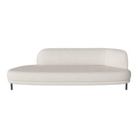 Modern white curved sofa with a smooth texture and minimalist design, complemented by sleek black metal legs.
