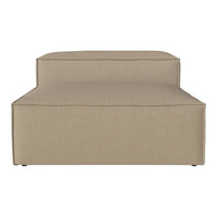 Beige upholstered chaise lounge with a minimalist design and smooth texture. Perfect for modern living spaces.