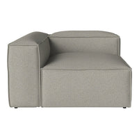 Gray upholstered sectional sofa with a smooth, minimalist design and subtle texture.