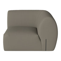 Curved accent chair in soft taupe fabric with a smooth, minimalist design. Perfect for modern decor.