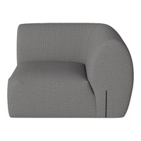 Gray curved armchair with textured fabric, featuring a modern and minimalist design. Perfect for contemporary decor.