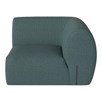 Curved teal sofa with textured fabric, featuring a subtle geometric pattern for modern decor.