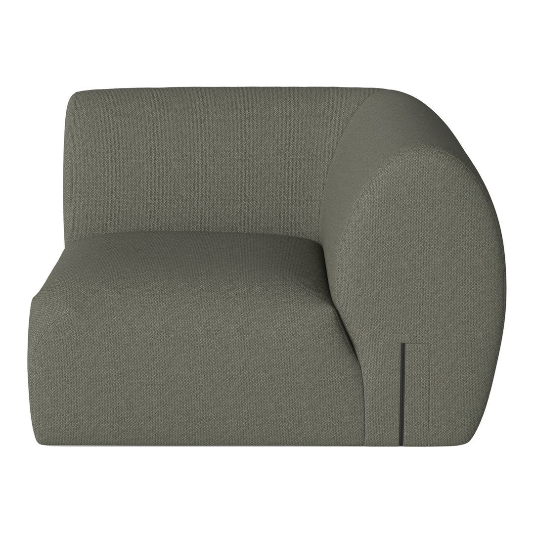 Sleek, curved armchair in soft olive green fabric with a textured pattern for modern decor.