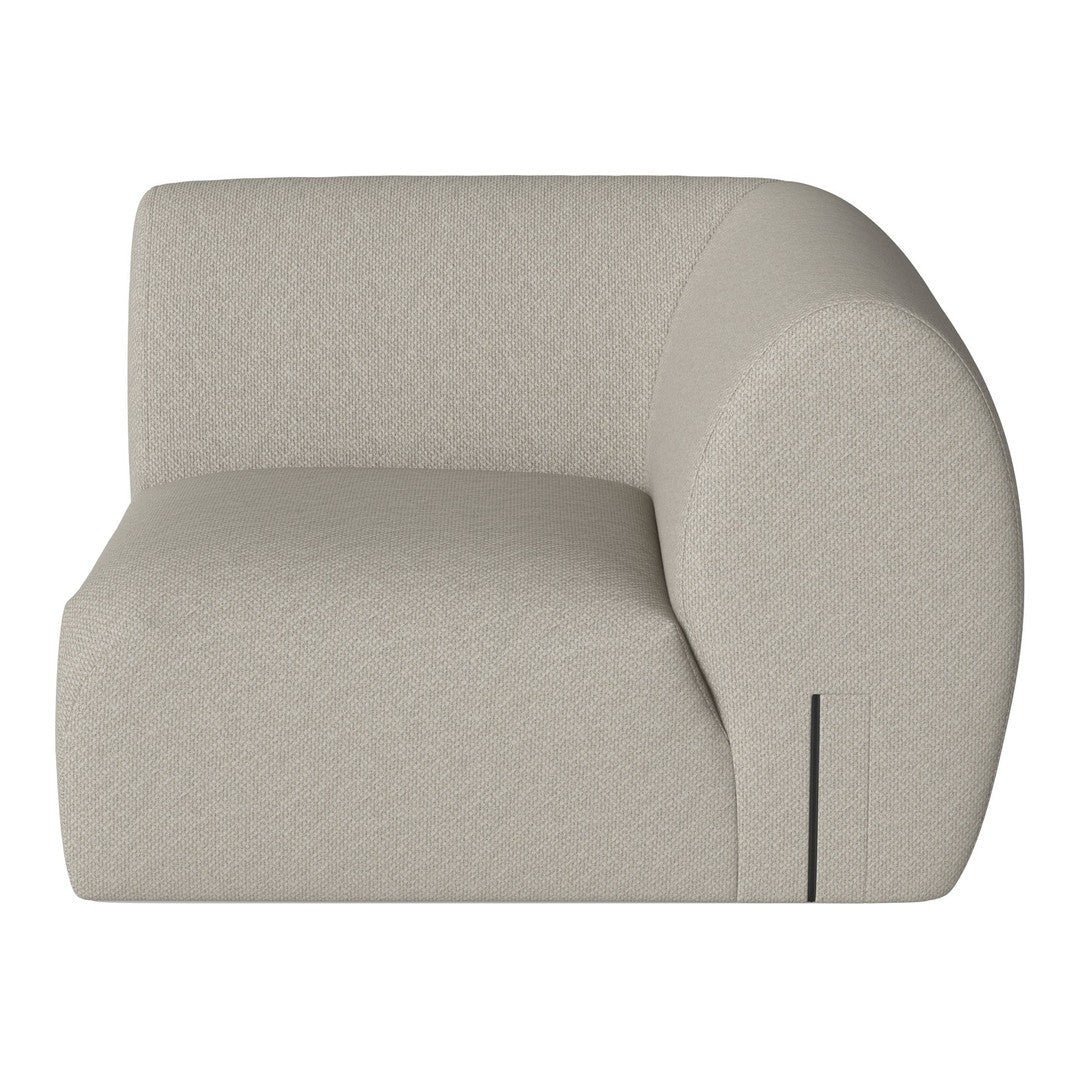 Light beige curved armchair with a smooth texture and minimalist design, perfect for modern decor.