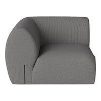 Gray upholstered corner chair with a textured pattern, featuring a modern and minimalist design.