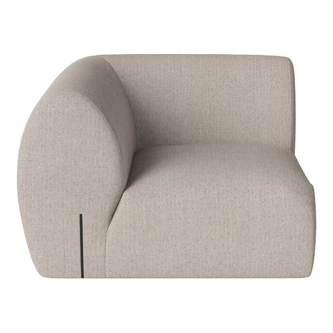 Curved beige armchair with a textured fabric and subtle pattern, showcasing a modern and minimalist design.