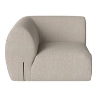 Curved beige armchair with a textured fabric and subtle pattern, showcasing a modern and minimalist design.