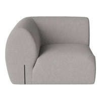 Light gray upholstered chair with a rounded back and minimalist design, showcasing a smooth, soft texture.