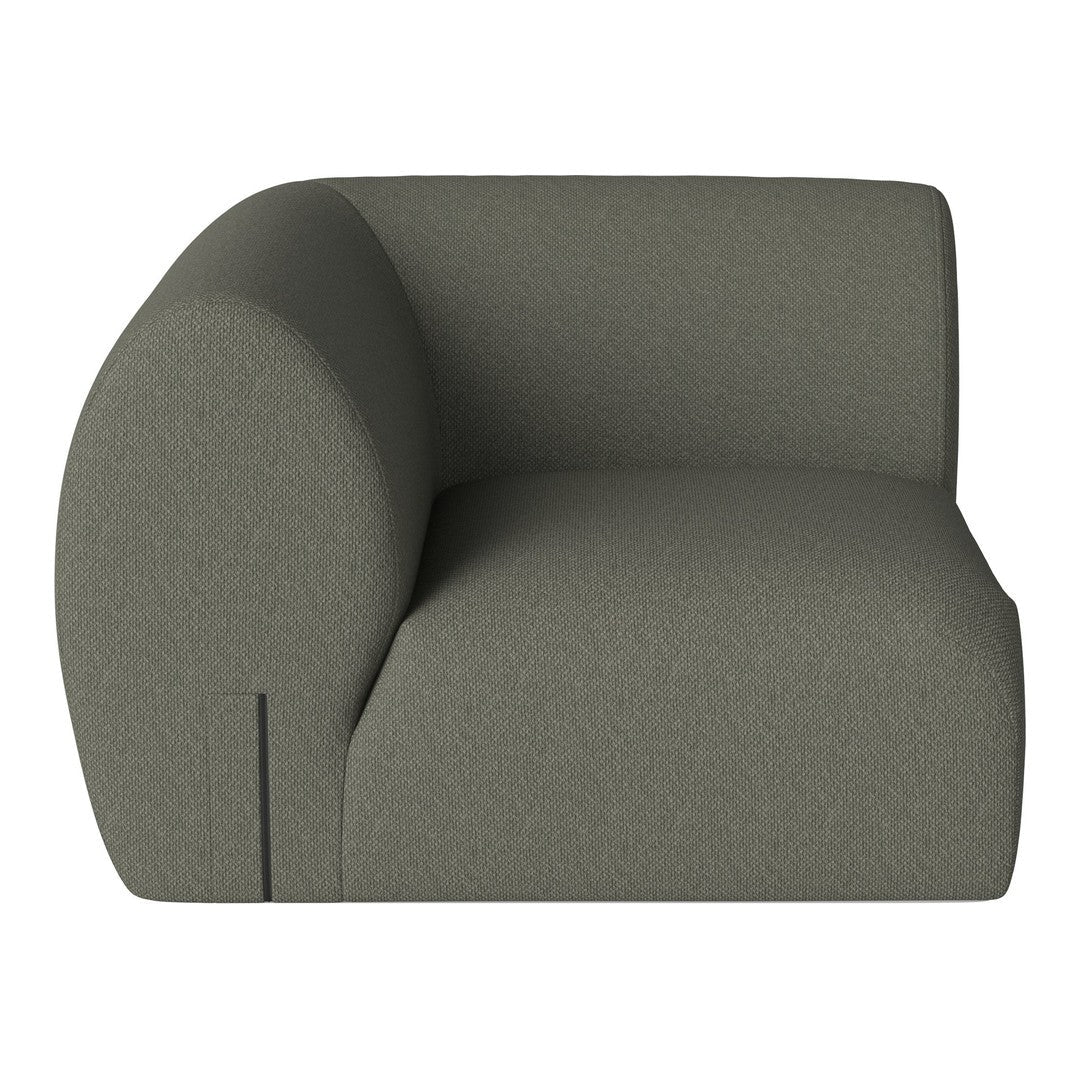Curved, modern sofa in a soft olive green fabric with a smooth, textured surface and minimalist design.