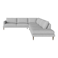 Light gray sectional sofa with a minimalist design and smooth fabric, featuring clean lines and elegant wooden legs.