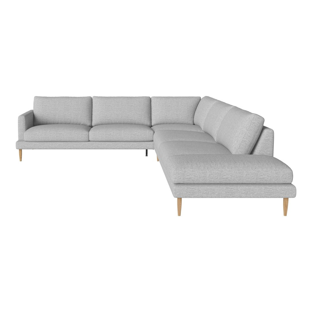 Light gray sectional sofa with a minimalist design and clean lines, featuring plush cushions and wooden legs.