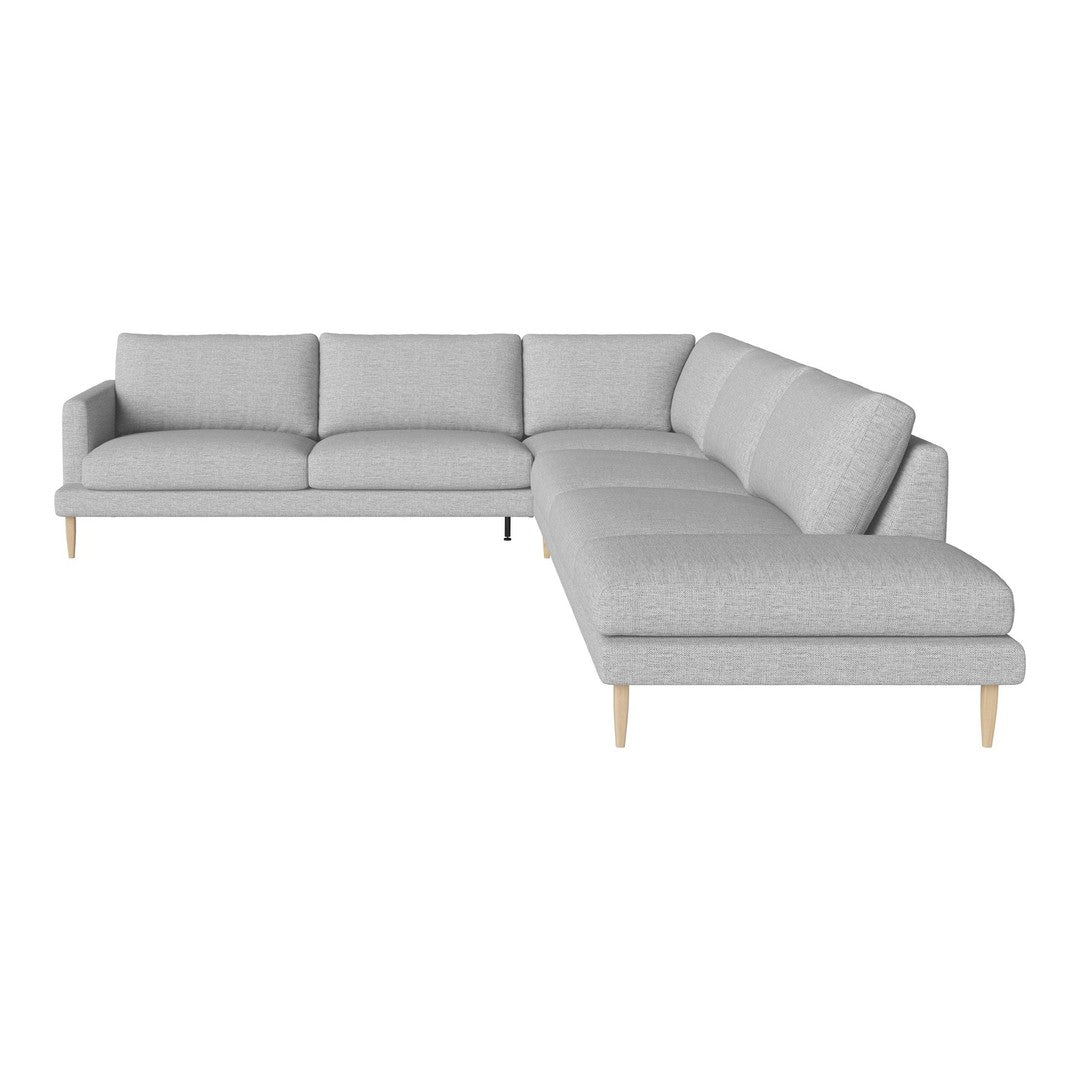 Light gray sectional sofa with a modern design and subtle textured fabric, complemented by natural wooden legs.