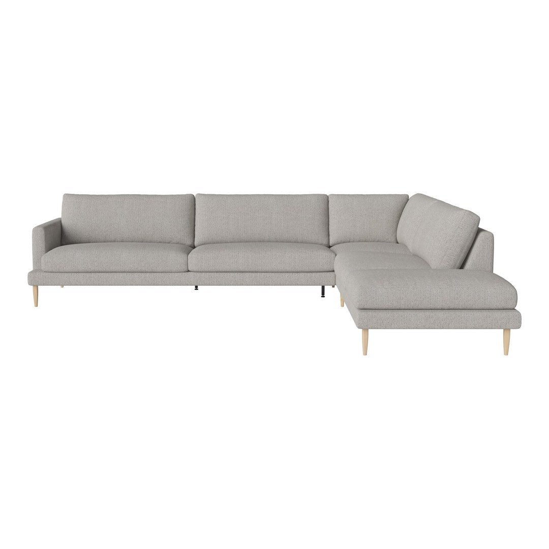 Light grey sectional sofa with clean lines and soft fabric, featuring natural wood legs for a modern look.