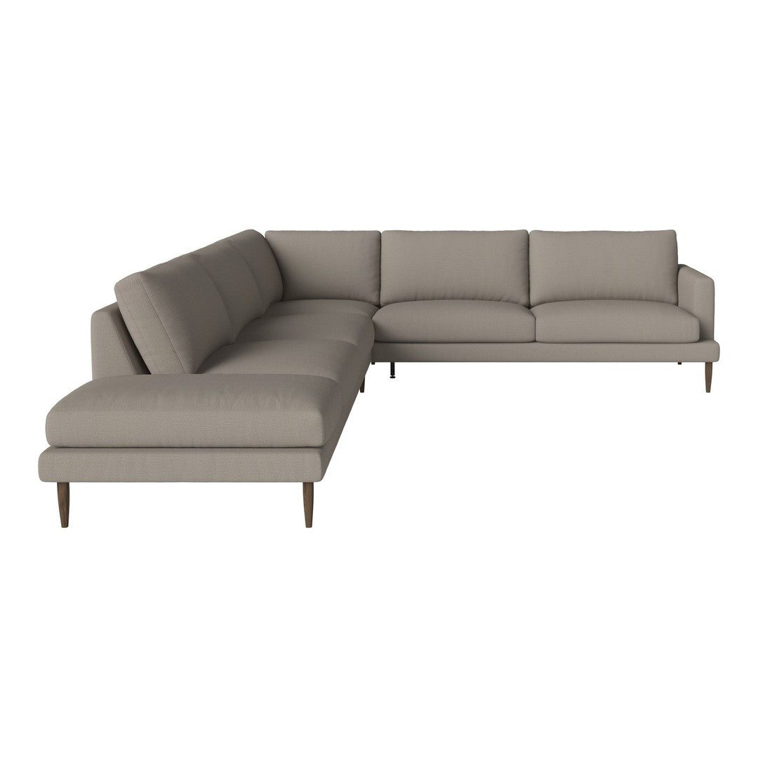 Modern L-shaped sofa in soft gray fabric with clean lines and minimalist design, accented by wooden legs.