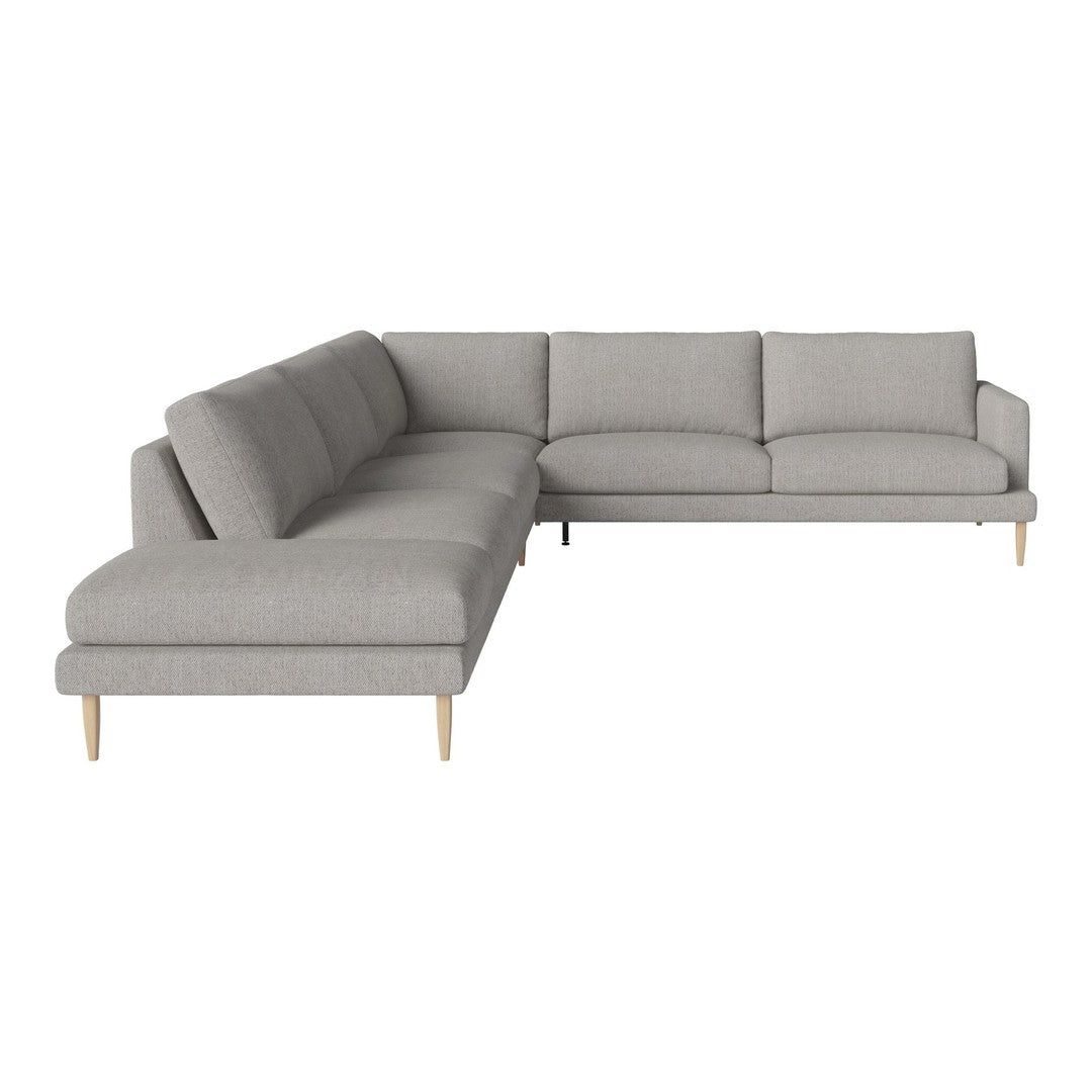 Light gray sectional sofa with a modern design and subtle textured fabric, featuring natural wood legs.
