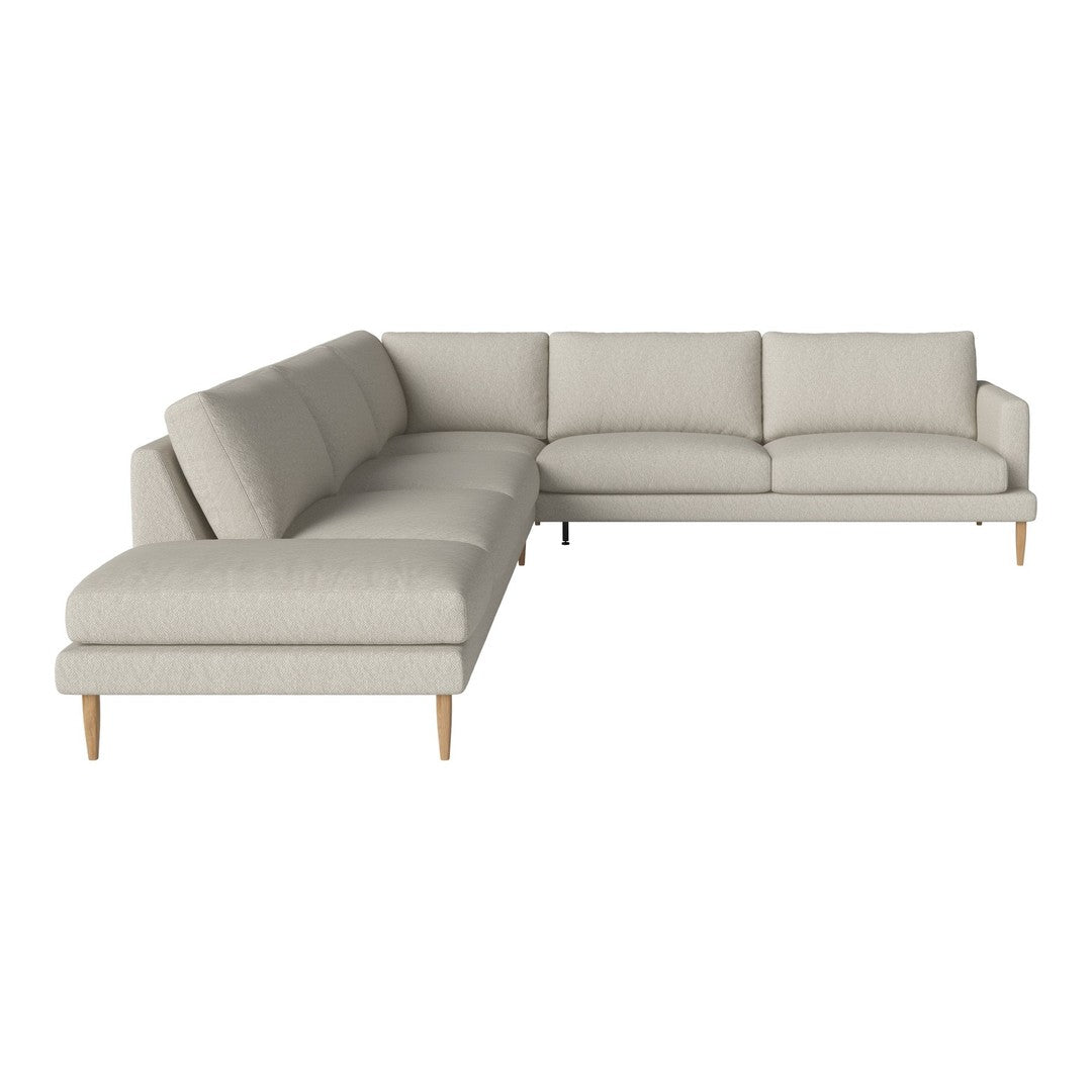 Beige sectional sofa with a smooth, textured fabric and light wooden legs, featuring a minimalist design and neutral color palette.