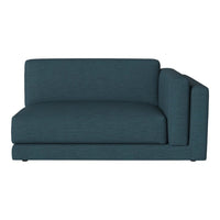 Teal upholstered sectional sofa with a sleek, modern design and textured fabric, perfect for contemporary living spaces.