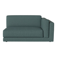 Teal upholstered sectional sofa with a soft, textured pattern for modern living spaces.