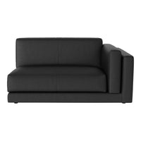 Black upholstered corner sofa with a sleek, minimalist design and smooth texture. Perfect for modern interiors.