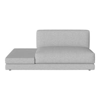 Gray sectional sofa with a sleek, minimalist design and soft fabric texture, ideal for modern living spaces.