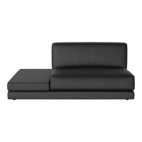 Sleek black leather chaise lounge with smooth texture and minimalist design, perfect for modern interiors.