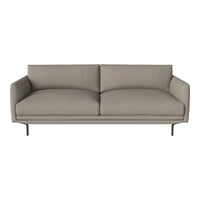 Modern beige sofa with clean lines and minimalist design, featuring soft, textured upholstery and black metal legs.