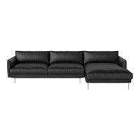 Modern black leather sectional sofa with smooth texture and sleek silver legs, perfect for contemporary interiors.