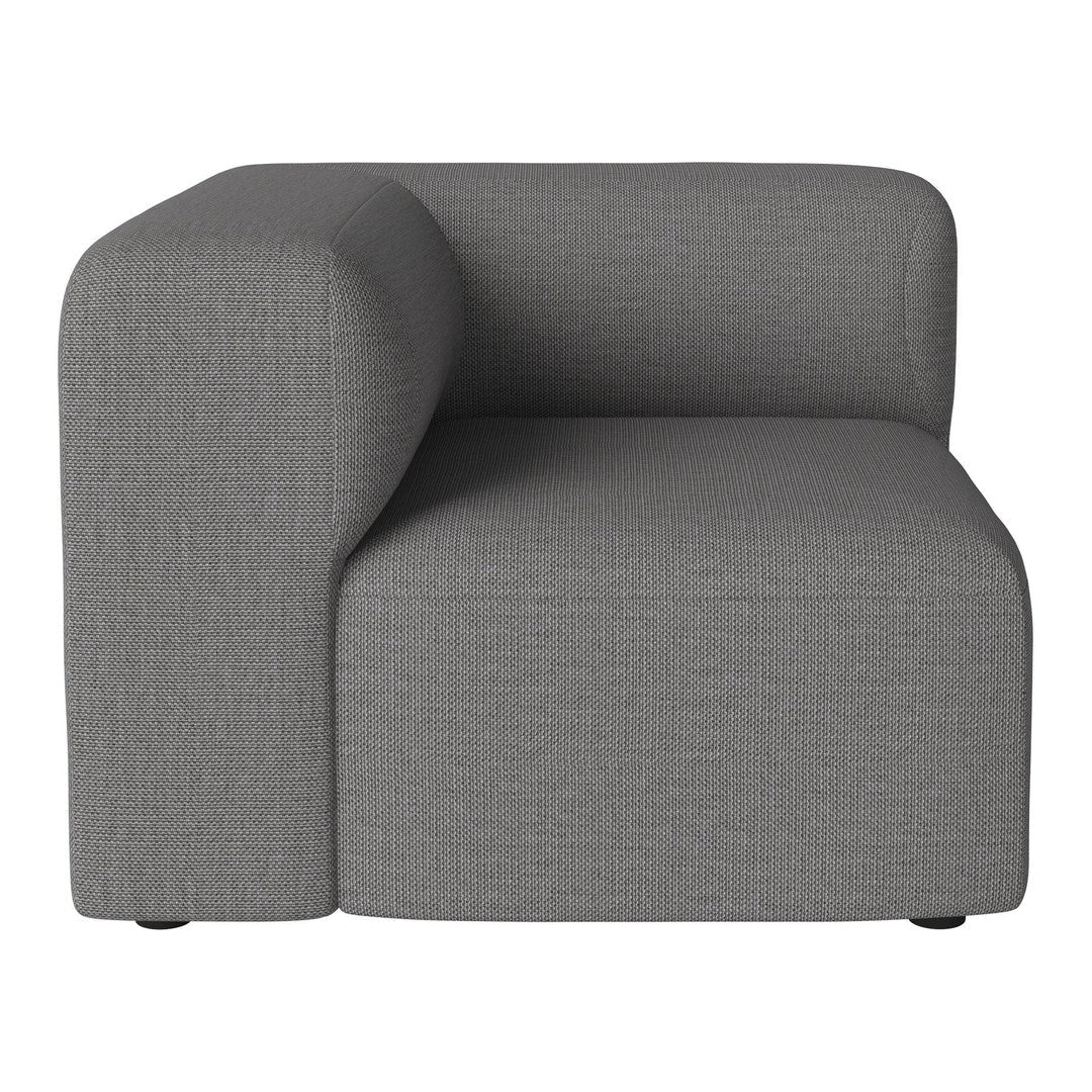 Gray upholstered corner chair with a smooth texture and modern, minimalistic design. Perfect for contemporary decor.