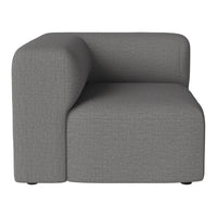 Gray upholstered corner chair with a smooth texture and modern, minimalistic design. Perfect for contemporary decor.