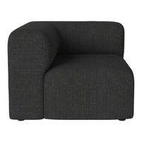 "Modern L-shaped armchair in solid dark charcoal fabric with subtle texture."