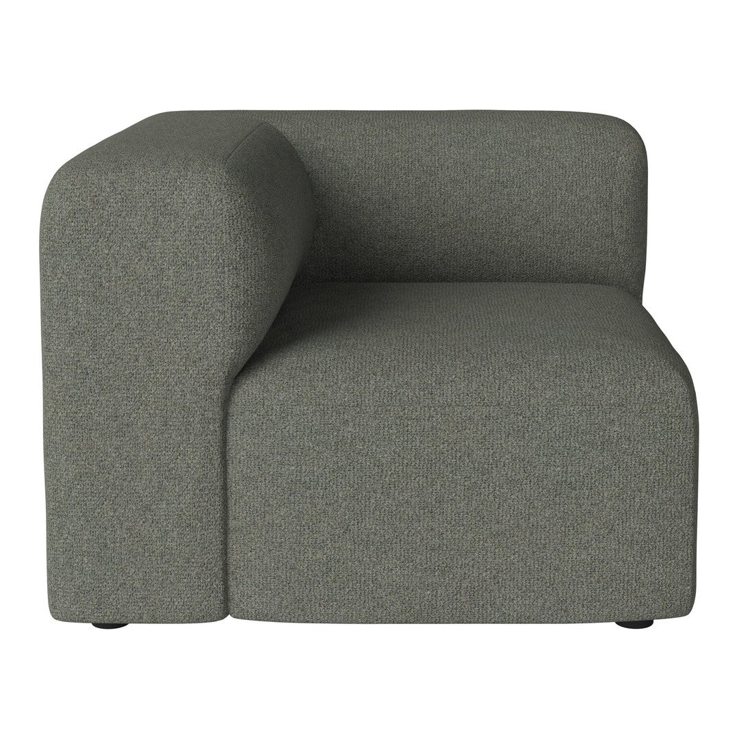 Curved grey upholstered corner chair with a soft texture and minimalist design. Ideal for modern living spaces.