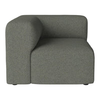Curved grey upholstered corner chair with a soft texture and minimalist design. Ideal for modern living spaces.