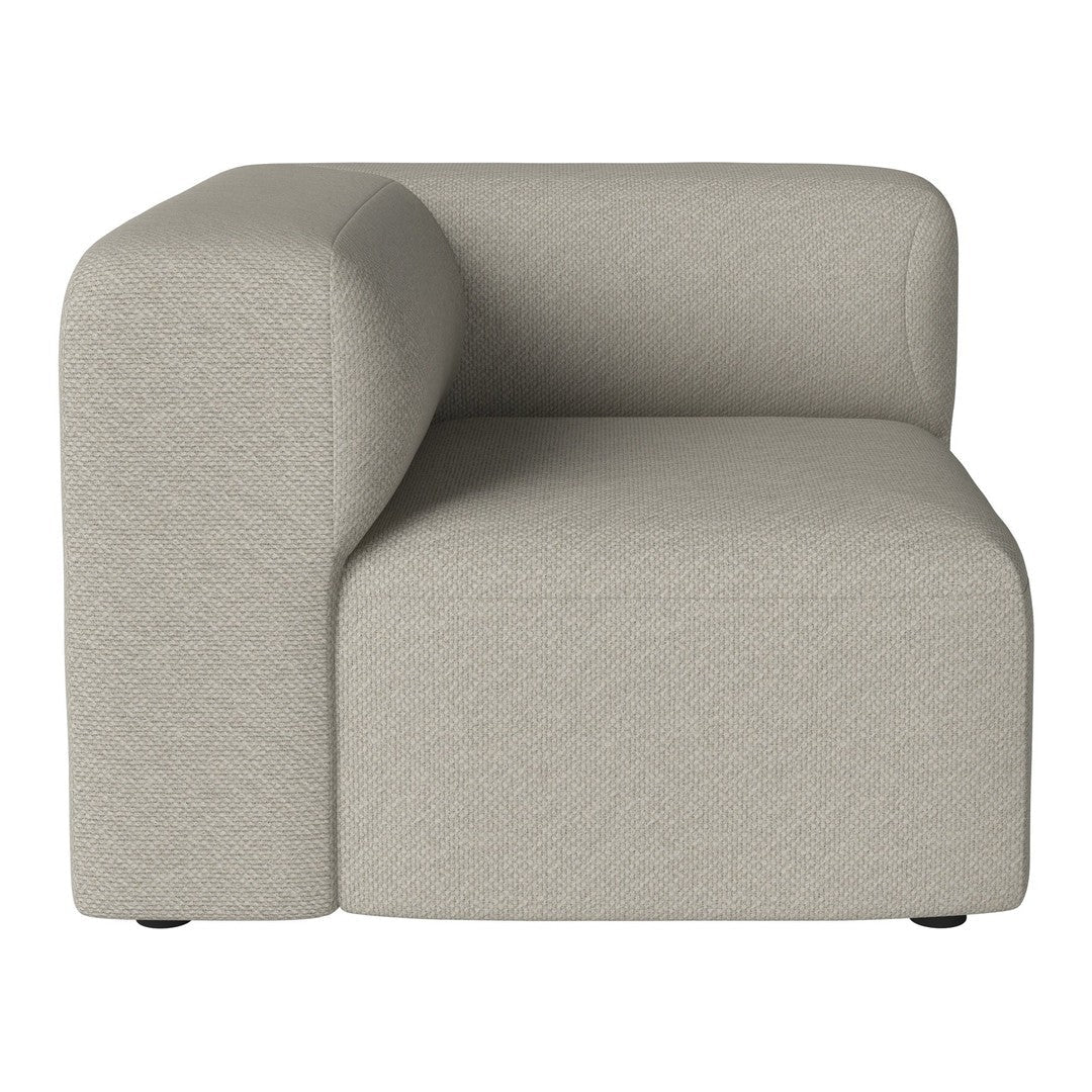Beige fabric corner chair with a smooth, modern design and rounded edges. Perfect for contemporary decor.