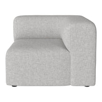 Gray upholstered corner chair with a smooth, textured fabric pattern, featuring clean, modern lines.
