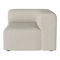 Beige upholstered corner chair with a smooth, minimalist texture, perfect for modern living spaces.
