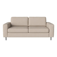 Light beige couch with a smooth texture and simple, modern design. Sleek silver legs complete the clean aesthetic.