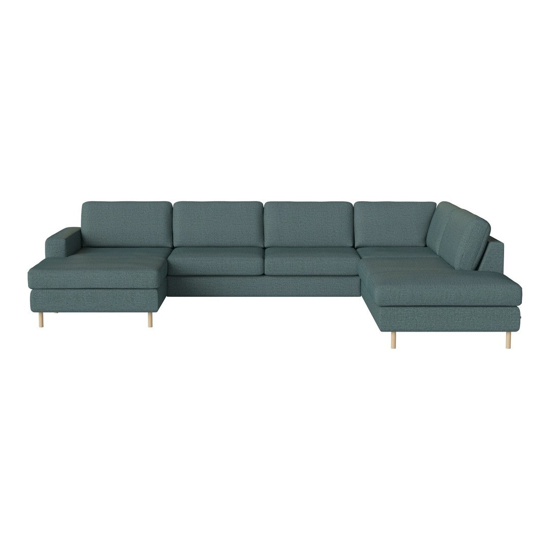 Teal sectional sofa with a minimalist design and light wooden legs, featuring soft, textured upholstery.