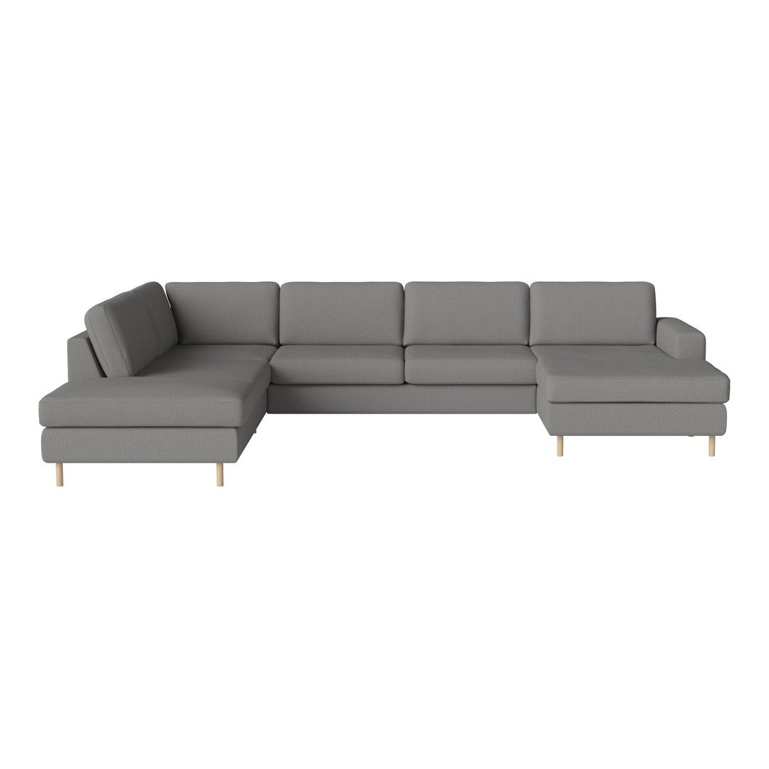 Modern gray sectional sofa with clean lines and soft fabric, featuring minimalist design and wooden legs.